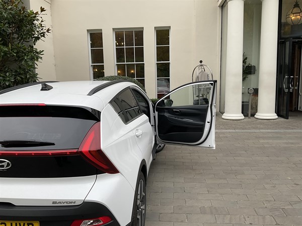Image of a white car parked in front of a white building