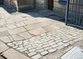 Picture of a curb and rough paving
