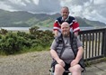 Image of two people in front of a mountain