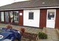 Picture of Winchelsea Beach Cafe - This shows the main use door during winter, but in the summer they have tables outside by the wider door. May not look too endearing, but the staff well make up for the looks.