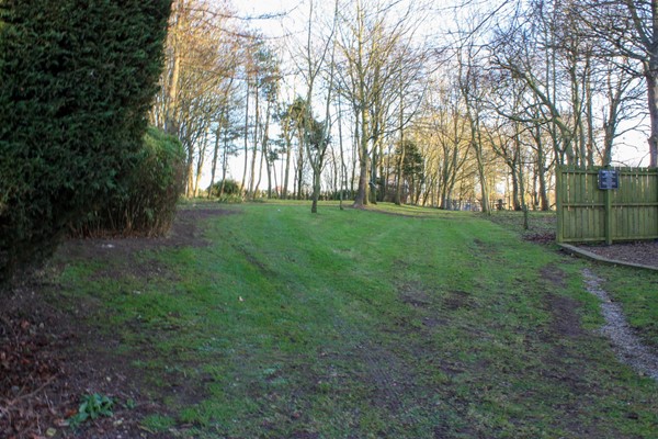 Grass/mud path towards the dog field. It's quite steep going up but then flattish once you're at the top.