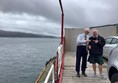 Two people pointing at each other on a ferry