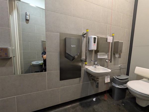 Image of accessible toilet with full-length mirror on the wall