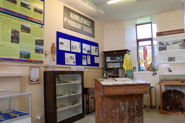 Display about Haroldswick Primary School with artefacts and information boards on the wall.