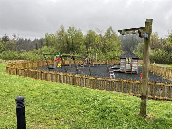 Image of a playground and a sign