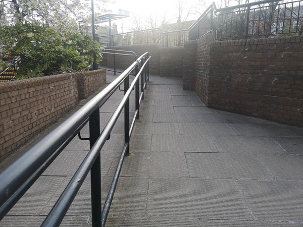Ramped access to the street and bus stop.