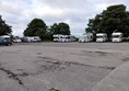Huge car park with several motorhomes around the edge.