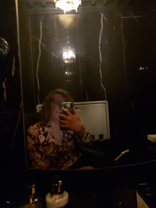Image of a person looking in a mirror taken with no flash