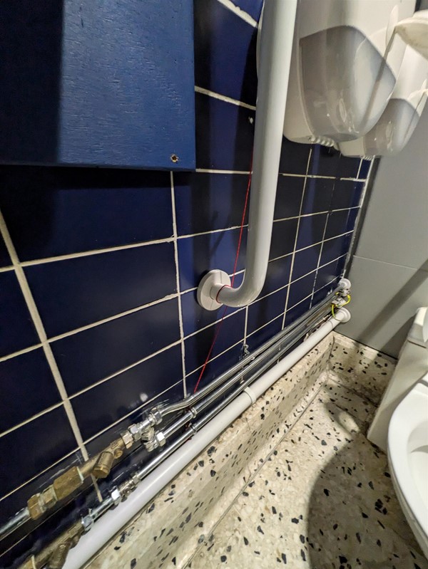 Image of a red cord wrapped around a grab rail