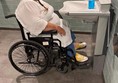 Picture of a wheelchair user in front of a height adjustable basin