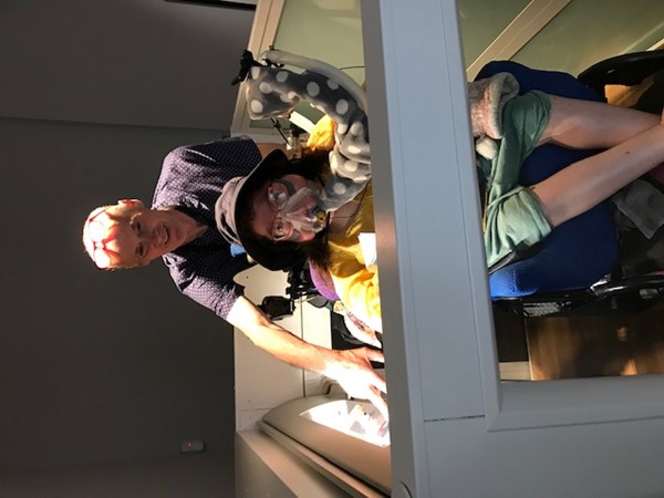 Image of two people, one in a powerchair