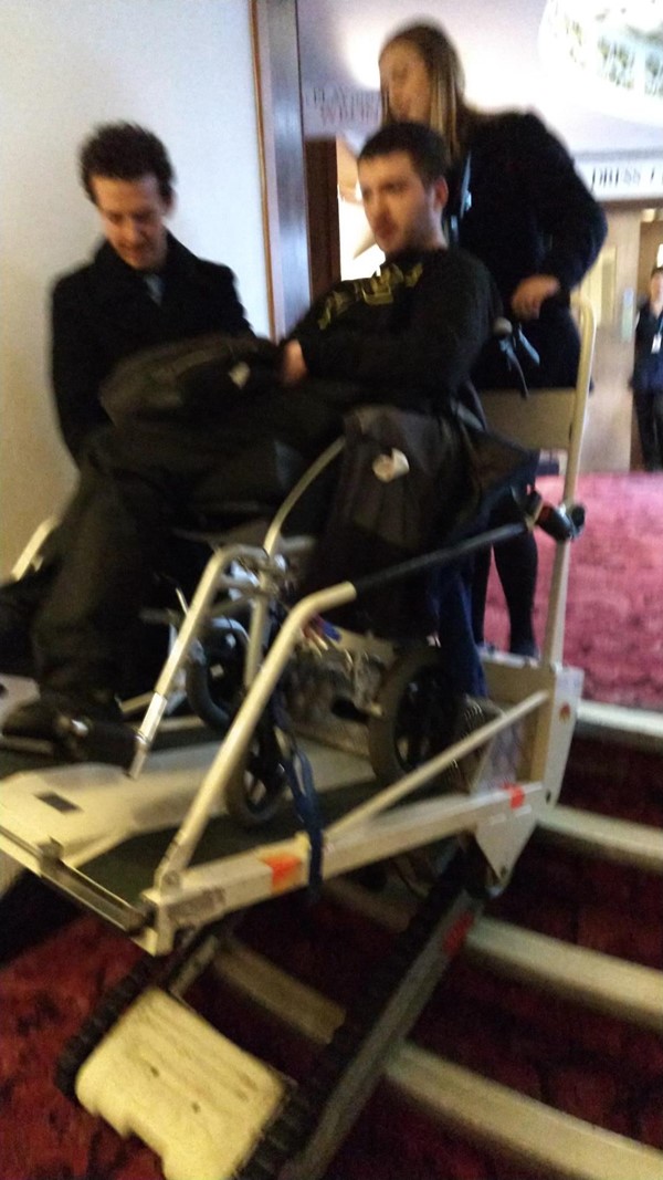 Stair climber being used. The figure in the chair is me and the staff pictured have given consent to use all attached photos