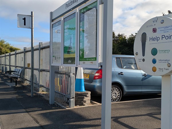 Image of assistance tannoy on platform 1, there is signage nearby displaying information