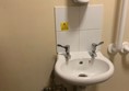 View of sink and handrails on right hand side.