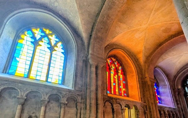 Image of three stained glass windows with different colour palettes
