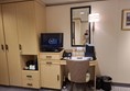 Dressing table, with drinks tray and telephone in place there is no other space. The power sockets are at the back under the mirror. The cupboard houses the fridge. The cupboard best to the tv houses the safe. The wardrobe had a drop down hanging rail