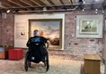 Image of a wheelchair user in a museum room