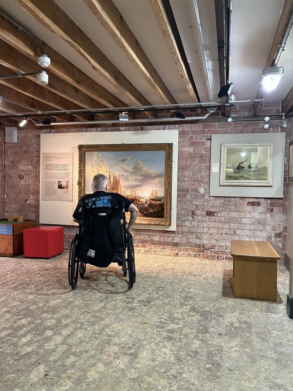Image of a wheelchair user in a museum room