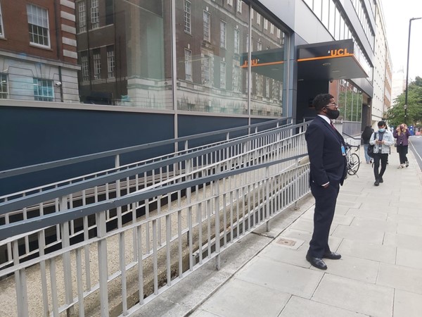 Picture of a man standing in front of a ramp which is behind a metal fence