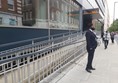 Picture of a man standing in front of a ramp which is behind a metal fence