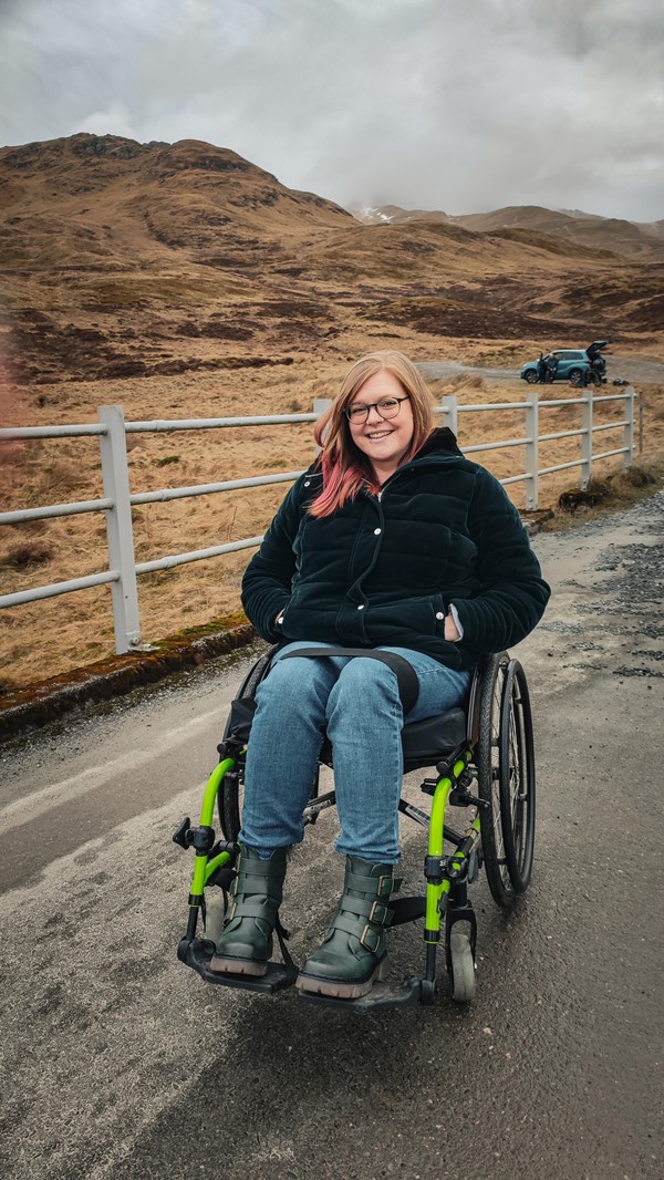 Helen sat in her wheelchair on a small bridge. This bridge crosses the stream and is a lovely spot.