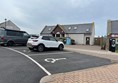 The accessible parking bays in the car park. The toilet building with the accessible toilet is in the background.