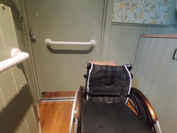 Image of a wheelchair inside an accessible toilet