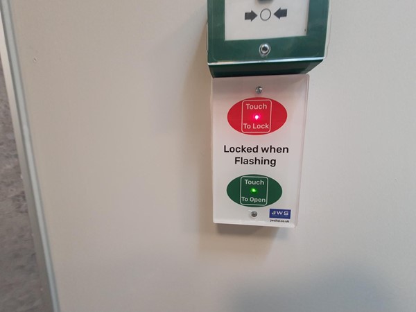 Image of the lock and door open button inside the Changing Places toilet.
