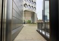 A pathway alongside the dark fencing