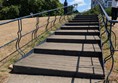 Image of a stairway in the park, there are rails and both side