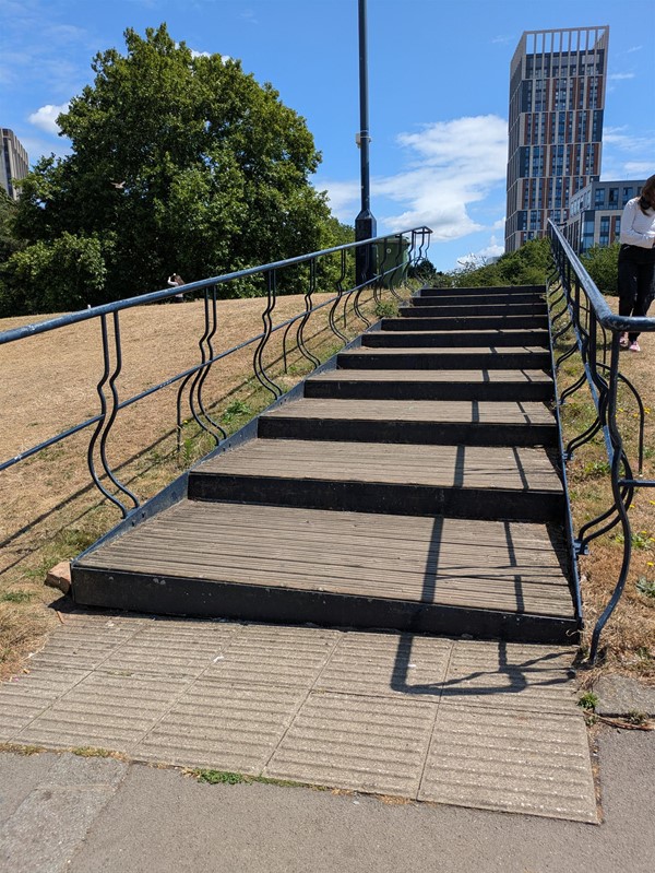 Image of a stairway in the park, there are rails and both side
