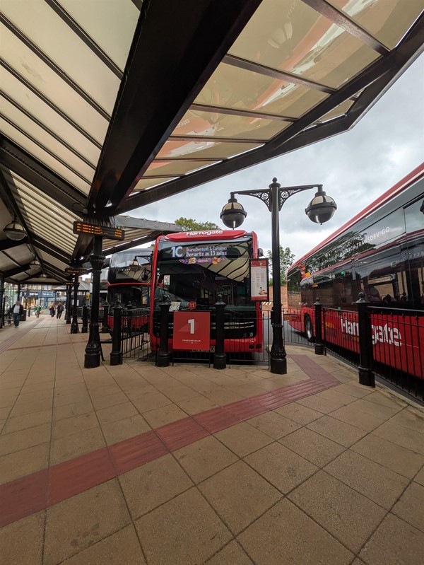Image of a bus pulling in alongside the bus shelter