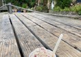 Image of a tub of ice-cream on an outdoor table.