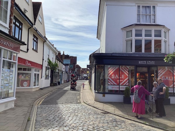 Picture of a cobbled road winding between buildings
