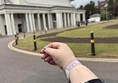 Image of a hand and De Monfort Hall