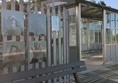 Image of rain shelter, the fence nearby has several BSL signs are part of an exhibit