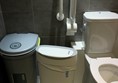 View of bins next to toilet