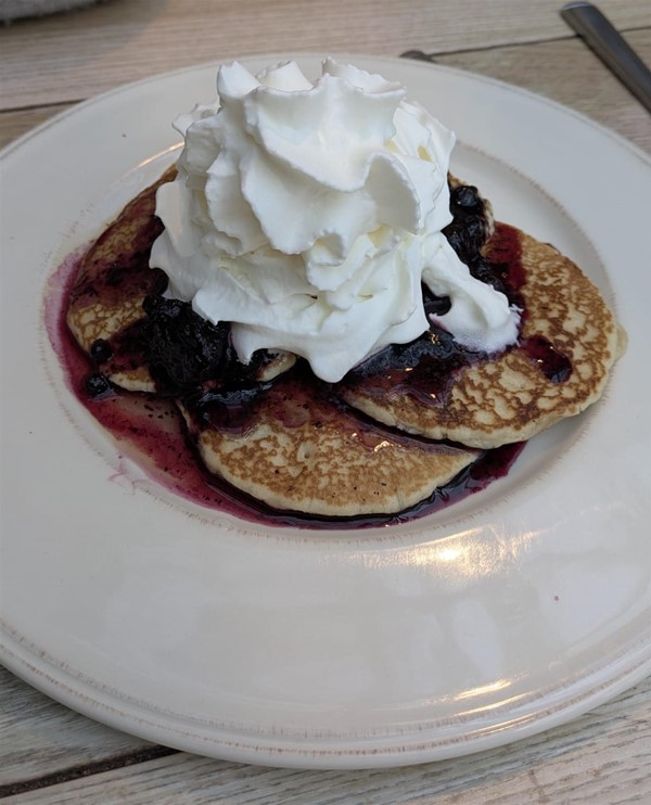 Pancake stack with blueberry compote,  an example of sweet delights.
