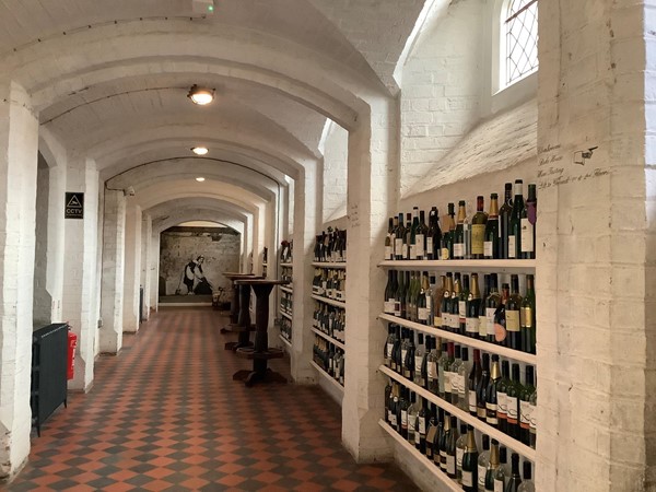 Picture of a corridor with wine bottles lining the sides