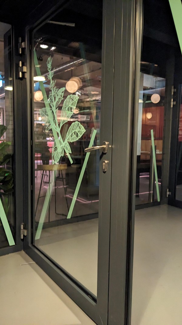 Very large doors to enter (despite awkward side view this photo is taken from). Glass means staff can see those entering which is great to signal to them if you need assistance entering.