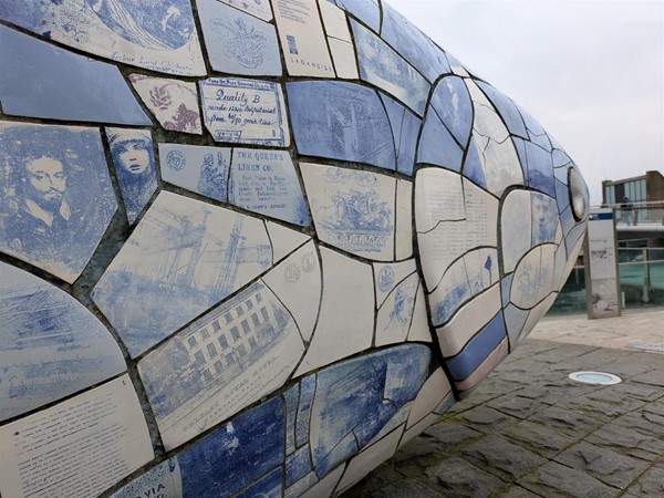 Image of The Big Fish showing images and text on the blue and white scales