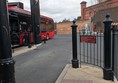 Image of a red bus, pulling into a bus stance