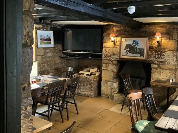 Exposed stonework invites us to partake of a drink at THE PLOUGH INN
