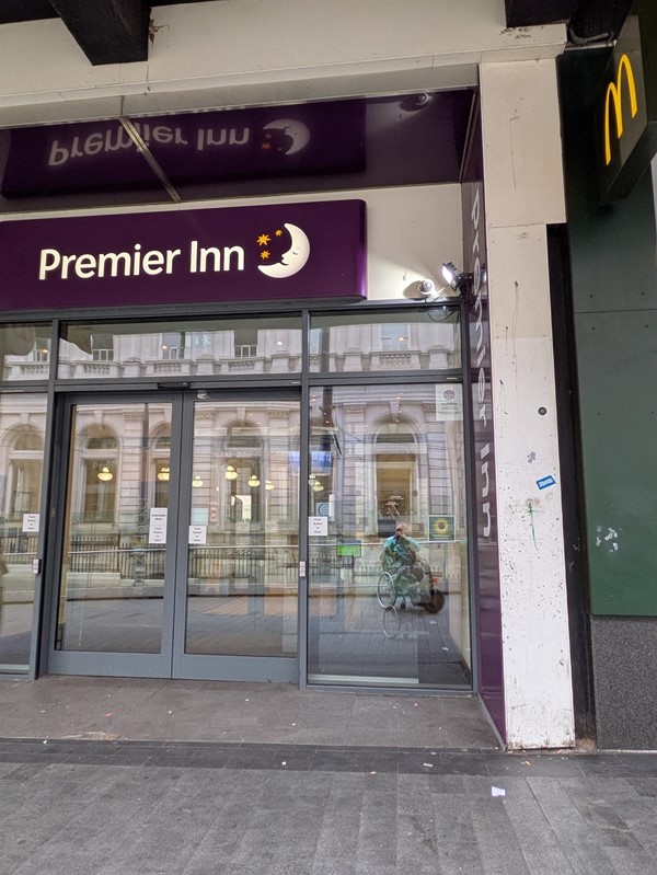 Image of entrance to the hotel, two sliding doors below a Premier Inn signage.