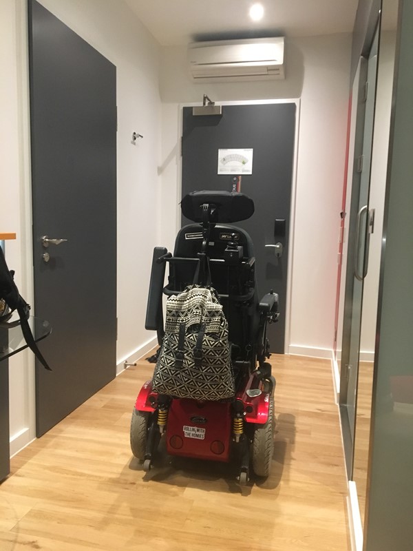 Hotel room, entry door in front, adjoining room door on left, bathroom on right