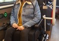 Wheelchair secured with Quantums electronic rubber arms.