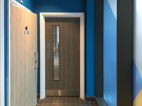 Entrance to the toilet area with the toilet door on the left