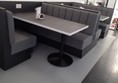 And another group of tables, very comfortable padded seats. In the background is the glass door to a separate room, which can be used for groups.