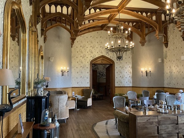 “THE OAK ROOM” One of the three original lounges of the old castle, beautifully restored, in this old Victorian mansion. It still has its historical charm, now mixed with modern facilities. This is one of the popular rooms of the old part of the castle, with its delightful wooden beams, picture frames of golden furnished frames. The cups on display add a real charm to the room. It’s a pleasant place to relax in, the drinks are very well made, and of course it’s here you enjoy any afternoon tea you have pre-booked. The chairs are reasonably comfortable, and the view through the windows towards the grounds offer the charm of the fresh green grass and shrubbery that helps the body and mind to unwind.
