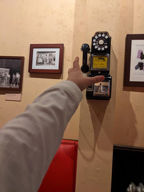 I cannot reach this phone to take a fun picture, nor hear what is being said. It is too far away and high up for wheelchair users.